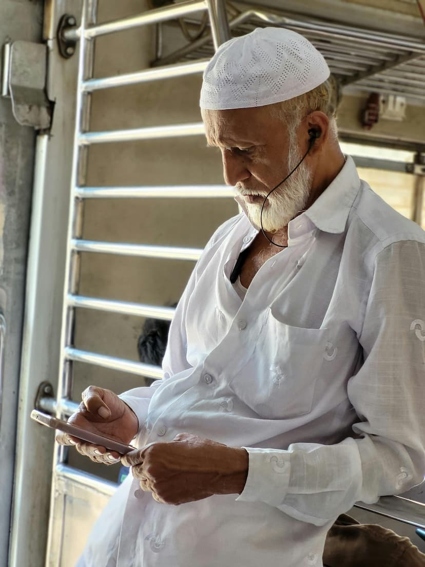 An older adult concentrating while using a mobile phone