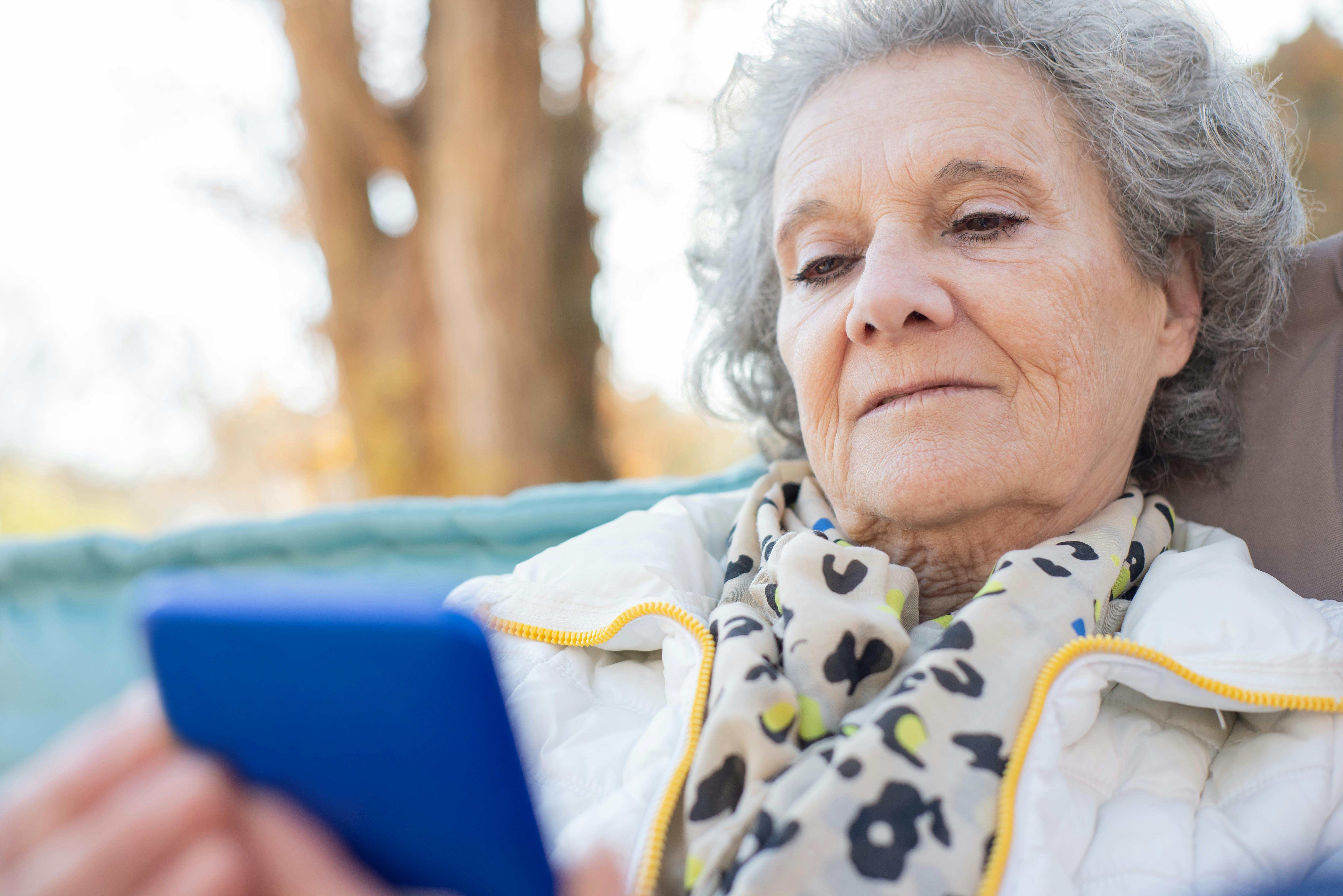 Senior woman over 70 using tablet for staying connected and managing everyday technology