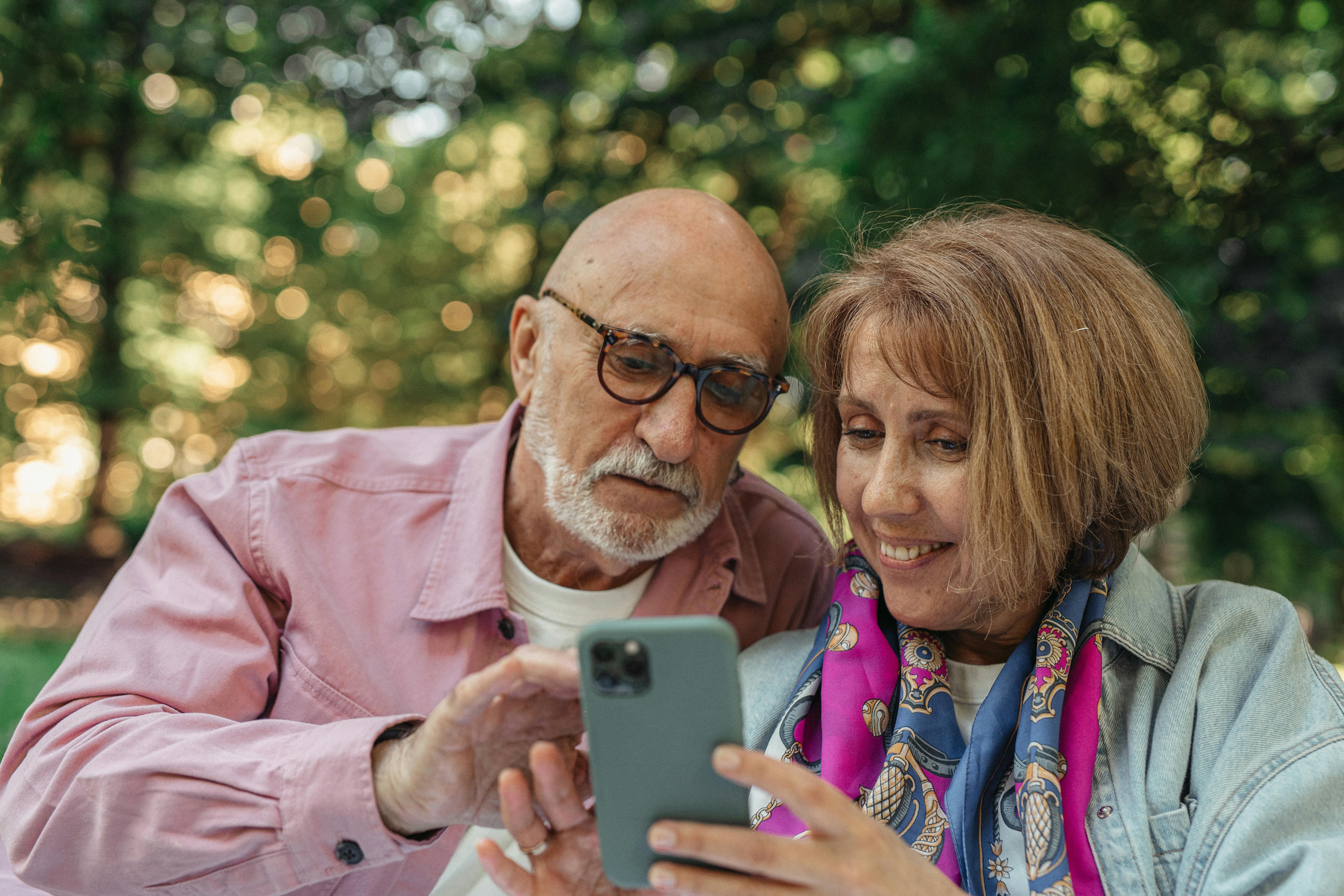 Elderly couple over 65 using smartphone together for everyday tasks and staying connected